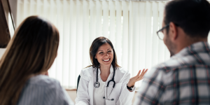 a doctor talking to a couple